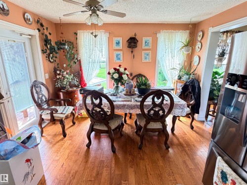 Dining area featuring wood-finish flooring, a ceiling fan with light fixture, and white trim work - 26418 Twp Rd 633, Rural Westlock County, AB 