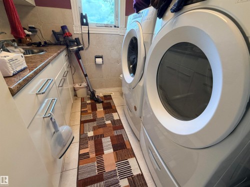 Laundry area featuring white front-load washer and dryer units - 26418 Twp Rd 633, Rural Westlock County, AB 