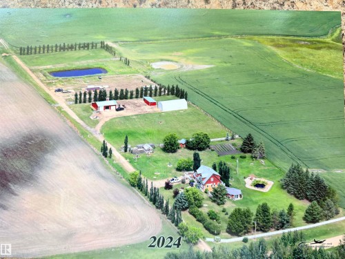 Expansive aerial view showcasing a large residential property and surrounding agricultural land - 26418 Twp Rd 633, Rural Westlock County, AB 