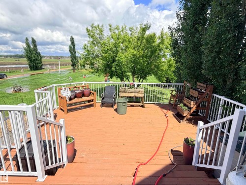 Expansive outdoor deck with wood-finish flooring and white railings - 26418 Twp Rd 633, Rural Westlock County, AB 