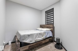 Neutral gray walls with dark trim detail frame a window with horizontal blinds - 