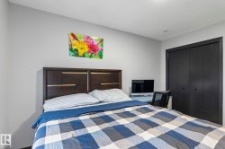 Bedroom featuring light gray walls and dark bifold closet doors - 