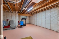 Unfinished basement with exposed wood joists and subfloor ceiling - 