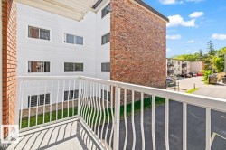 Private balcony with white metal railing and a concrete floor - 