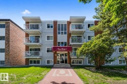 Multi-story residential building featuring brick accents and light grey siding - 