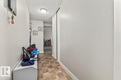 Entryway featuring textured ceiling, flush-mount lighting, and durable tiled flooring - 202 10330 113 Street, Edmonton, AB 