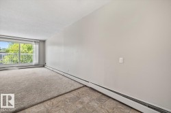 Bright living space featuring a full-width window with vertical blinds, providing abundant natural light - 
