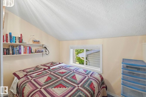 Room featuring angled ceilings, light-toned walls, and a single window with white trim - 1410 47436 Range Rd. 15, Rural Leduc County, AB 