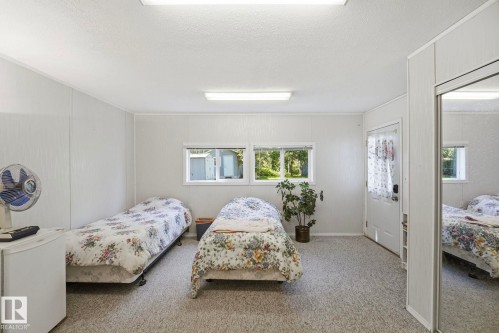 Spacious room featuring light-colored walls and soft carpeting - 1410 47436 Range Rd. 15, Rural Leduc County, AB 