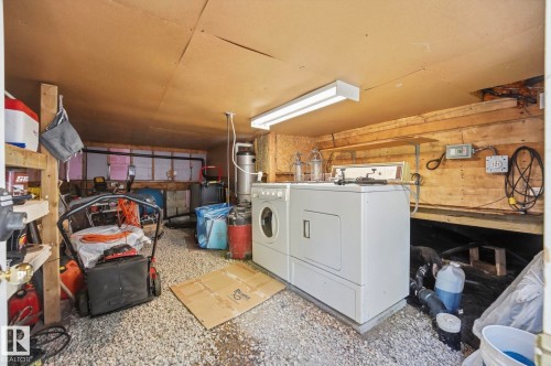 Utility area with gravel flooring, exposed wooden wall paneling, and a wood-finish ceiling - 1410 47436 Range Rd. 15, Rural Leduc County, AB 