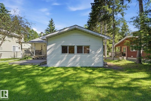 Exterior siding with multiple windows, surrounded by mature trees - 1410 47436 Range Rd. 15, Rural Leduc County, AB 