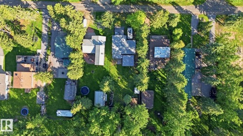 Aerial view showcasing multiple residential properties with verdant landscaping - 1410 47436 Range Rd. 15, Rural Leduc County, AB 