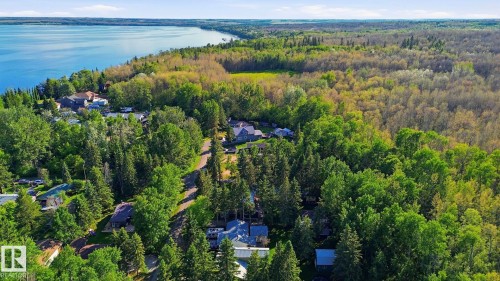 Expansive treed landscape with a body of water in the background - 1410 47436 Range Rd. 15, Rural Leduc County, AB 
