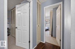 Hallway featuring multiple panel doors and louvered bifold doors - 