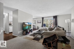 Carpeted living area featuring a sliding glass door with balcony access - 