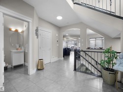 Open-concept living area featuring dark wood-finish flooring, a modern flush-mount ceiling light, and recessed lighting - 
