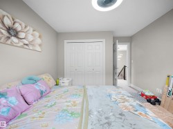 Spacious room featuring multiple windows with horizontal blinds, light-colored walls, and a patterned carpet - 