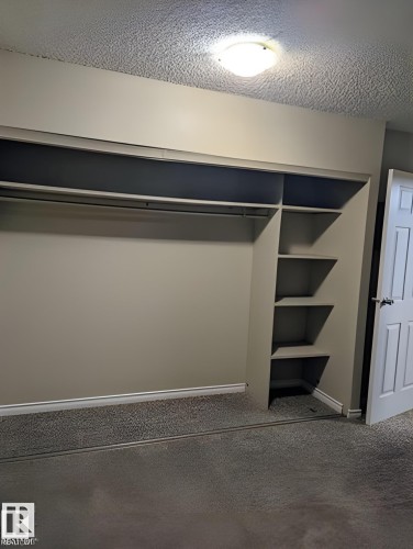 Built-in closet system with hanging rods and integrated shelving - 611 12831 66 Street, Edmonton, AB 