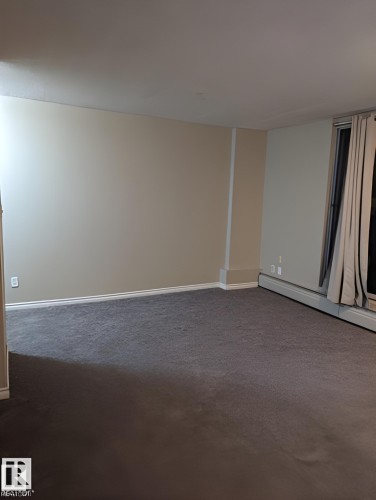 Spacious room with neutral wall tones, grey carpeting, and white baseboards - 611 12831 66 Street, Edmonton, AB 