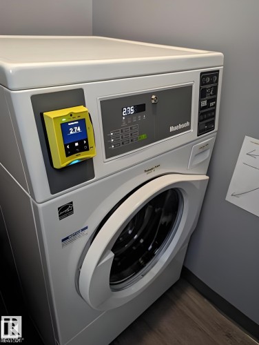 Stackable laundry appliances featuring a front-loading washer and integrated payment system - 611 12831 66 Street, Edmonton, AB 