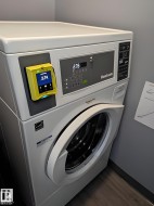 Stackable laundry appliances featuring a front-loading washer and integrated payment system - 