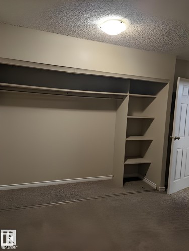 Built-in closet system featuring hanging rods and integrated shelving - 611 12831 66 Street, Edmonton, AB 