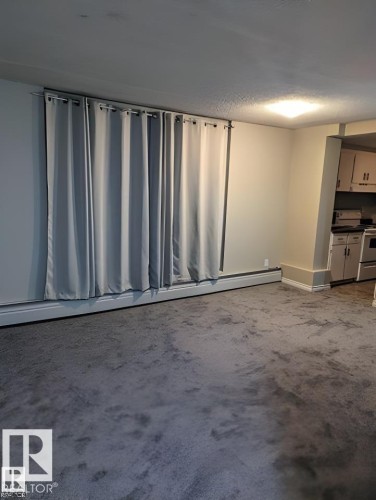 Open concept living area featuring neutral wall paint and gray carpeting - 611 12831 66 Street, Edmonton, AB 