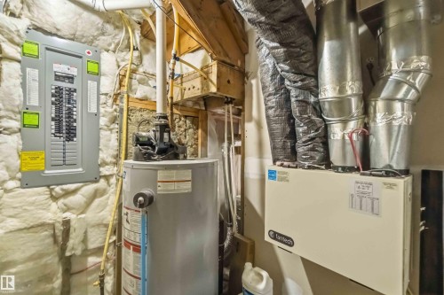 Electrical panel, hot water heater, and HVAC system with exposed ductwork and insulation - 6036 106 Street, Edmonton, AB 