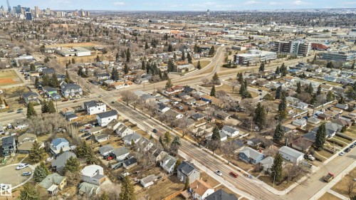 Expansive aerial perspective showcasing a residential neighborhood with a diverse mix of architectural styles, tree-lined streets, and mature landscaping - 6036 106 Street, Edmonton, AB 
