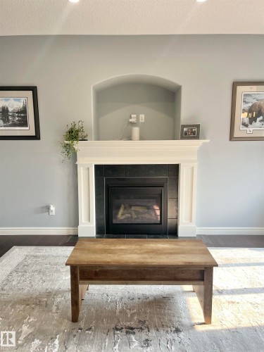 Built-in fireplace with a black tile surround and a white mantle - 108 South Creek Wynd, Stony Plain, AB 
