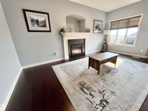 Fireplace with a white mantel and an arched alcove - 108 South Creek Wynd, Stony Plain, AB 