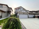 Two-story dwelling with a multi-gabled roofline and light grey siding - 108 South Creek Wynd, Stony Plain, AB 