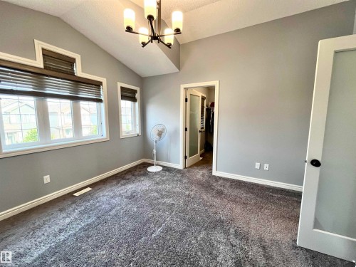 Vaulted ceilings featuring a contemporary chandelier - 108 South Creek Wynd, Stony Plain, AB 