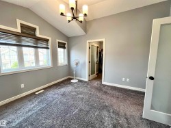 Vaulted ceilings featuring a contemporary chandelier - 