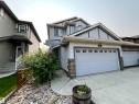 Contemporary two-story home featuring light gray siding and stone accents - 108 South Creek Wynd, Stony Plain, AB 