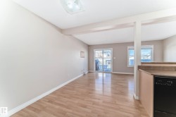 Open concept living area with wood-finish flooring - 