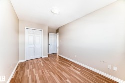 Room with wood-finish flooring, light neutral wall paint, and white baseboards - 