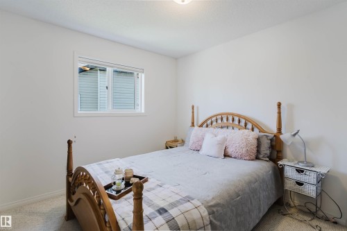 Bedroom with light-colored walls and soft carpet flooring - 1743 Melrose Crescent Sw, Edmonton, AB 