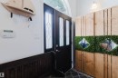 Entryway featuring a black door with decorative glass inserts and an arched transom window - 1743 Melrose Crescent Sw, Edmonton, AB 