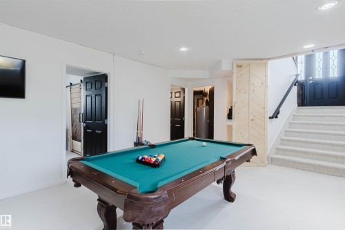 Spacious finished lower level featuring a billiards table, recessed lighting, and light-toned flooring - 1743 Melrose Crescent Sw, Edmonton, AB 