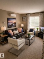 Carpeted living area featuring a wall-mounted mini-split system, window with blinds, and drapery rod - 