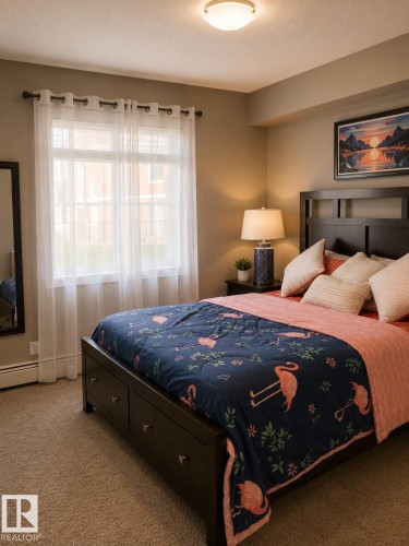 Bedroom featuring neutral wall paint, carpet flooring, a window with sheer curtains, a built-in baseboard heater, and a flush mount ceiling light - 128 1510 Watt Drive Sw, Edmonton, AB 