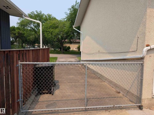 Concrete driveway with chain link gate - 6415 147 Avenue, Edmonton, AB 