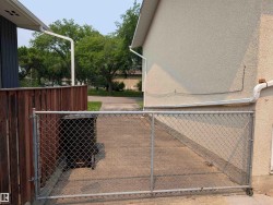Concrete driveway with chain link gate - 