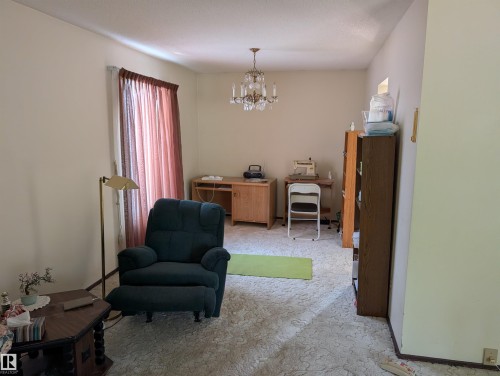 Spacious interior room featuring light-toned walls and a textured ceiling - 6415 147 Avenue, Edmonton, AB 