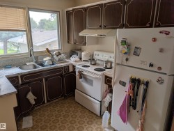 Functional kitchen with brown cabinetry featuring decorative trim - 