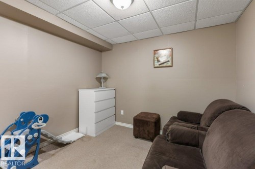 Finished room featuring neutral-toned walls, recessed lighting, and a suspended acoustic tile ceiling - 18609 54 Avenue, Edmonton, AB 