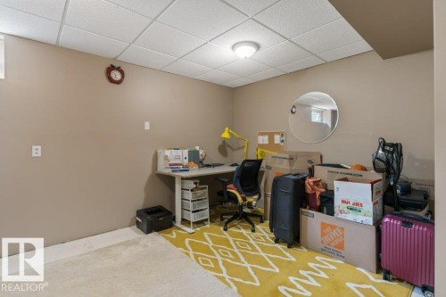 Finished room featuring light beige walls and a white acoustic ceiling - 18609 54 Avenue, Edmonton, AB 