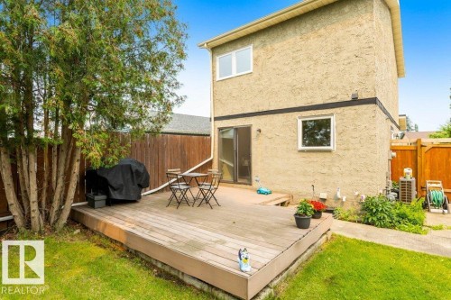 Expansive backyard deck featuring wood-finish decking and a wooden privacy fence - 18609 54 Avenue, Edmonton, AB 