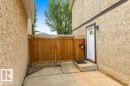 Private side yard featuring a wood fence and concrete patio - 18609 54 Avenue, Edmonton, AB 